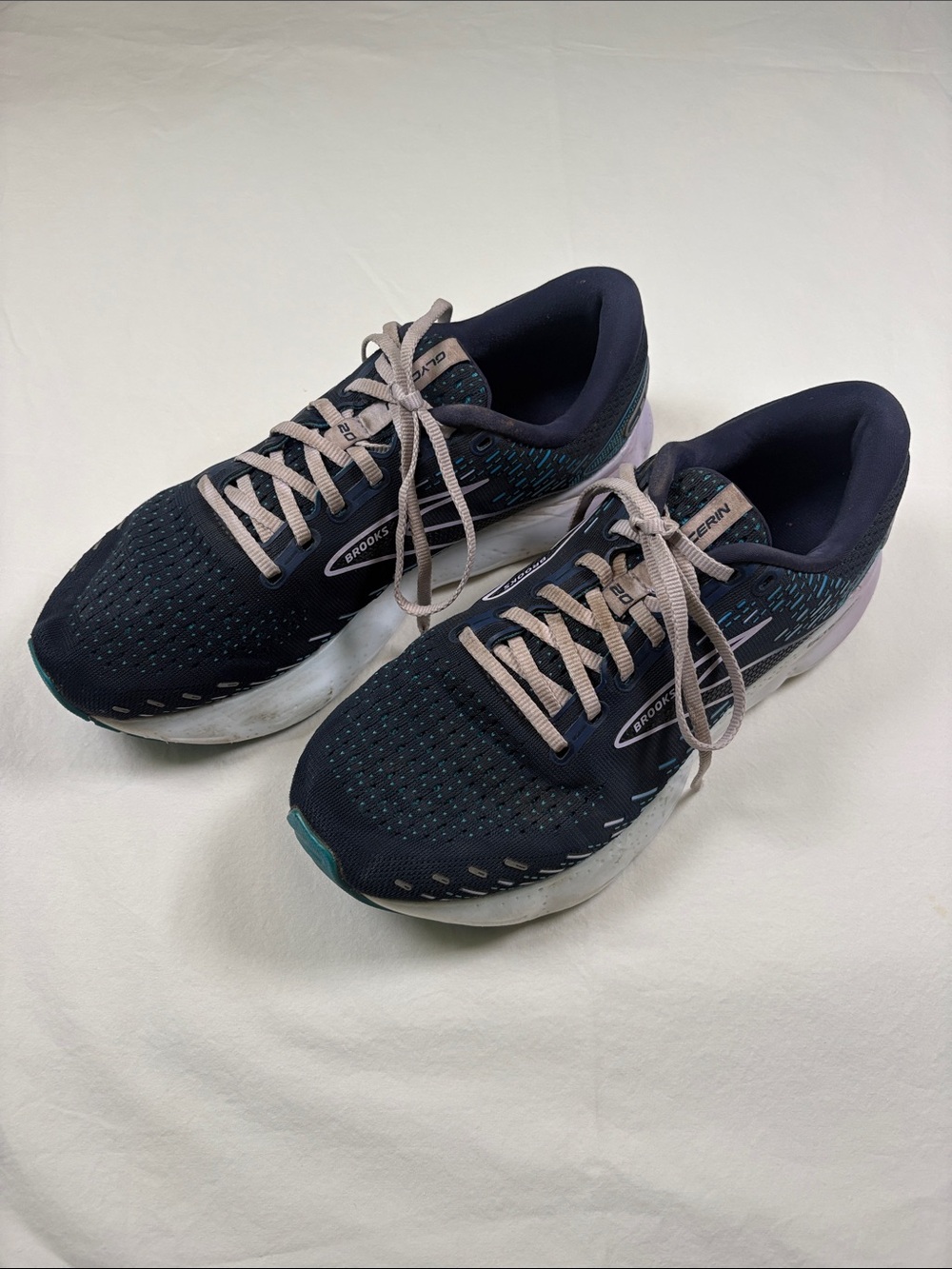 Brooks dark navy running shoes with pale pink laces